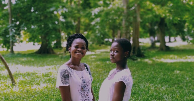 Two siblings holding hands during school holidays at home