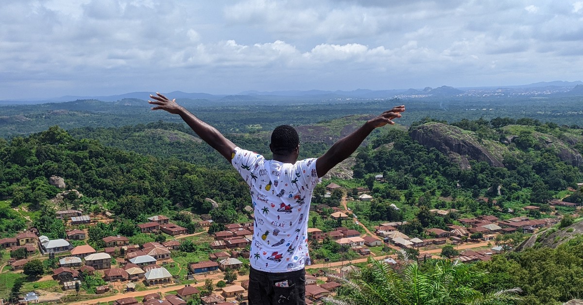 A man standing on a hill during an excursion