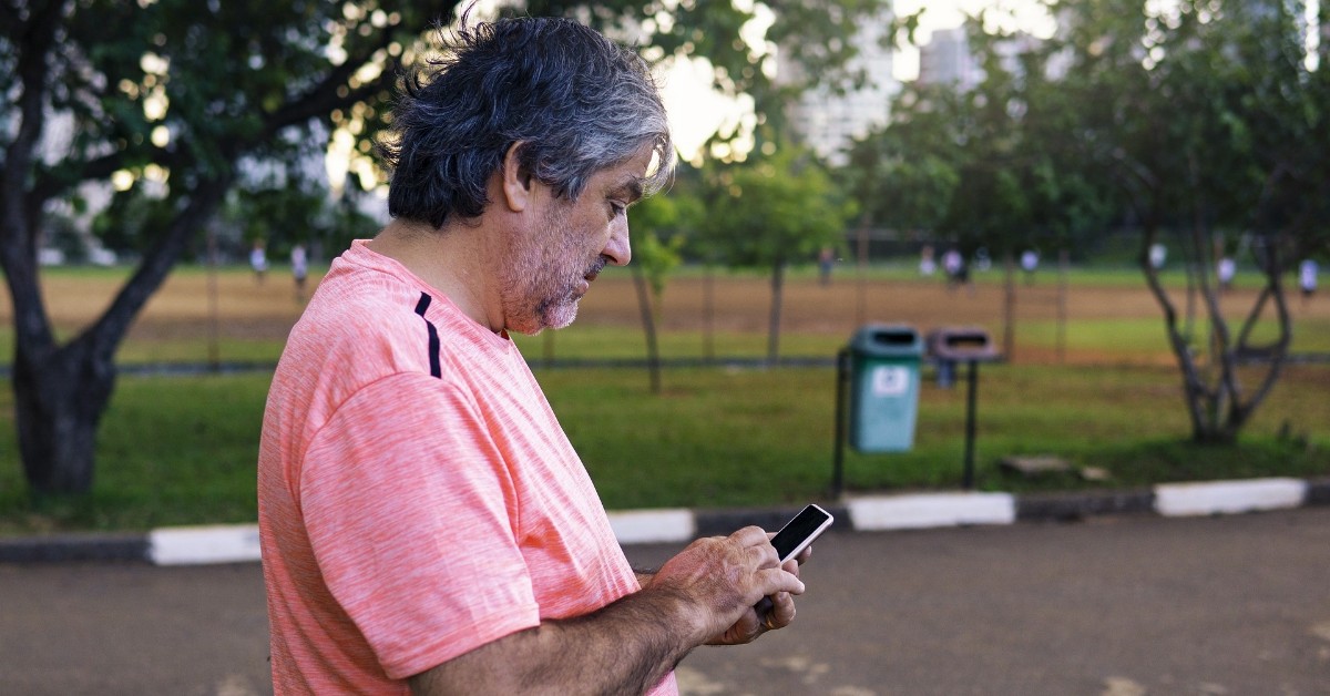 Father pressing phone on how to avoid being scammed