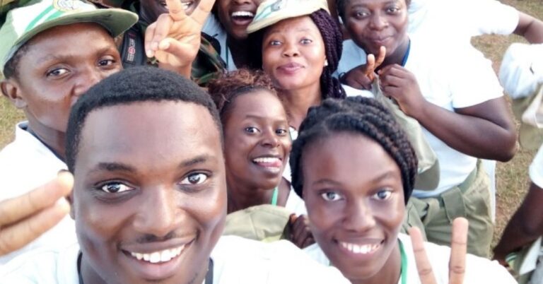 Corps members smiling while on camp