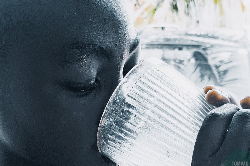 a boy drinking water as tips for good health and fitness