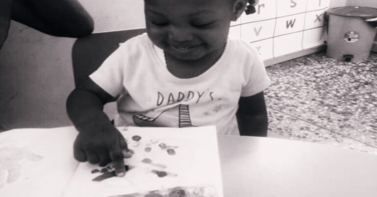 A child Following directions on coloring a note